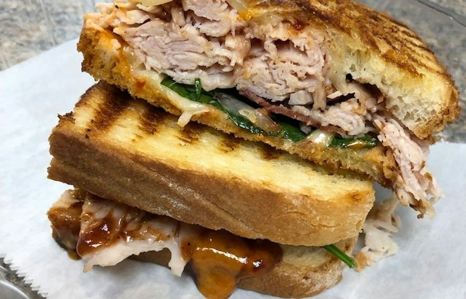 Grilled turkey panini stacked high at Mabe's Sandwich Shop
